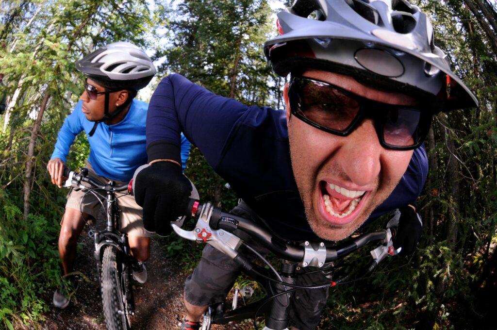 Mountain bikers on a trail, one is screaming